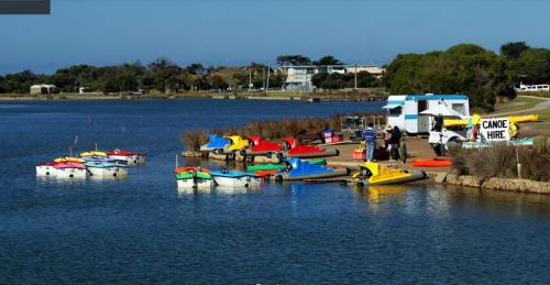 a bunch of boats are docked in a body of water at Holiday Home in the Heart of Anglesea in Anglesea