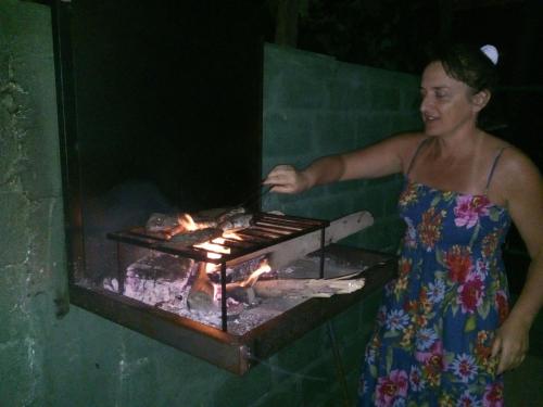 a woman is cooking food on a grill at Airport Green Hotel in Katunayake