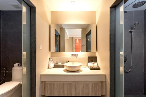 a bathroom with a sink and a mirror at Cape Sienna Phuket Gourmet Hotel & Villas - SHA Extra Plus in Kamala Beach