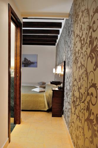 a bedroom with a bed in a room with a hallway at Al Casaletto Hotel in Settecamini