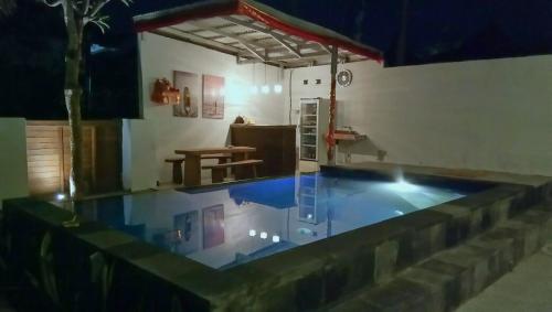 a house with a pool in the middle of a room at Mahi Mahi House in Nusa Lembongan