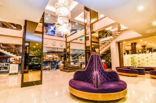 a purple chair in the middle of a shopping mall at El Cavana Bandung in Bandung