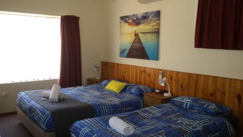 a hotel room with two beds and a window at Kadina Village Motel in Kadina