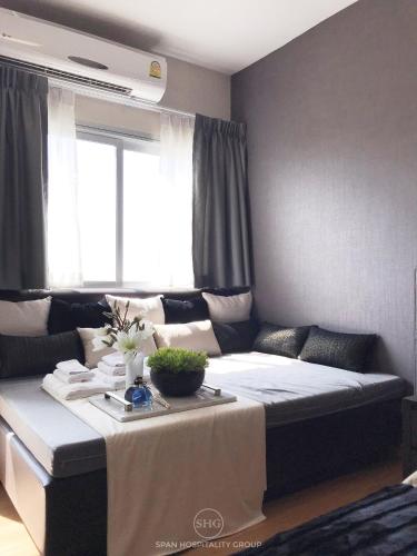 a living room with a couch and a table at Stay in Style, Stay On The Cloud RS504 in Chiang Mai
