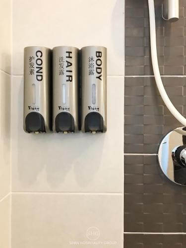 a group of batteries hanging on a wall in a bathroom at Stay in Style, Stay On The Cloud RS504 in Chiang Mai