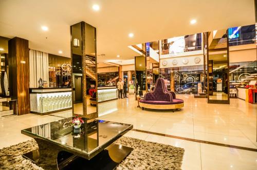 a shopping mall with a purple chair and a glass table at El Cavana Bandung in Bandung