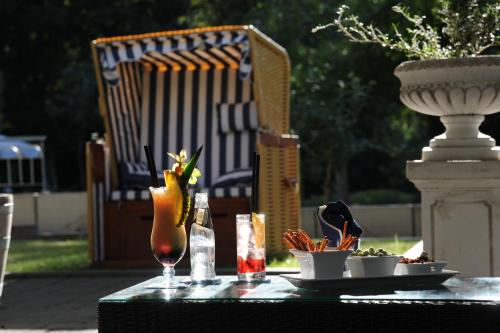 a table with a drink and a plate of food at Waldhotel Rheinbach in Rheinbach