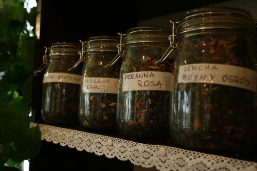 a row of jars of nuts on a shelf at Gościniec i Herbaciarnia Pod Złotą Łyżwą in Białka Tatrzanska