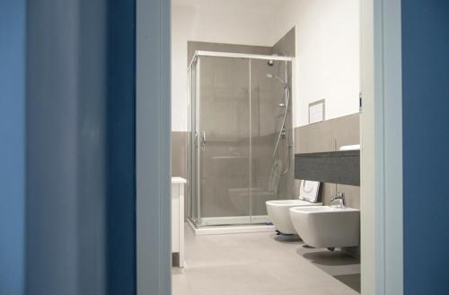 a bathroom with a shower and two sinks and a toilet at "Panoramic Terrazza - Napoli" in Naples