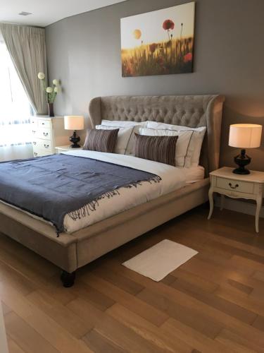 a bedroom with a large bed and two lamps at Marrakesh Residence 325 in Hua Hin