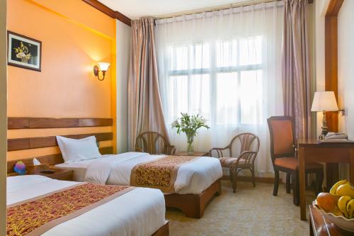 Postel nebo postele na pokoji v ubytování Eastland Hotel