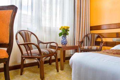 Ένα ή περισσότερα κρεβάτια σε δωμάτιο στο Eastland Hotel