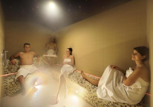 a group of people sitting in a bath room at Hotel Resort Relax in Dolní Vltavice