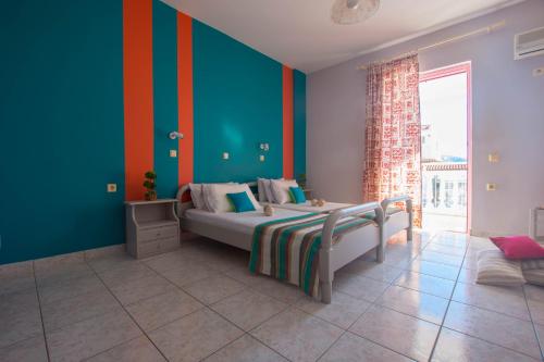 a bedroom with a bed and a colorful wall at Bona Vista Studios in Laganas