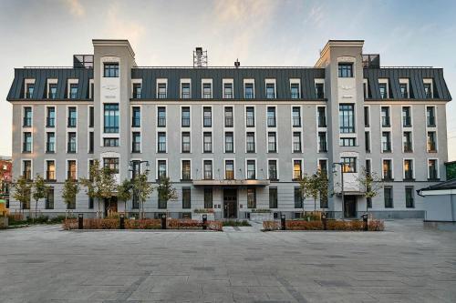 a large building with a courtyard in front of it at Moss Boutique Hotel in Moscow