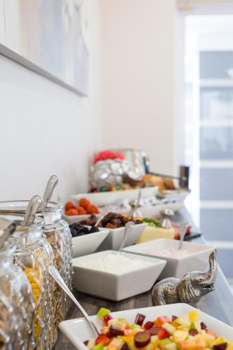 a table with plates of food on a counter at Atlantic Beach Villa in Cape Town