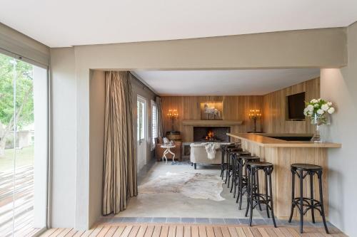 a kitchen with bar stools and a fireplace at Bosch Hoek Golf & Lodge in Balgowan