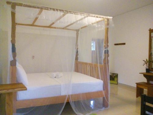 a bedroom with a bed with a canopy at Airport Green Hotel in Katunayake