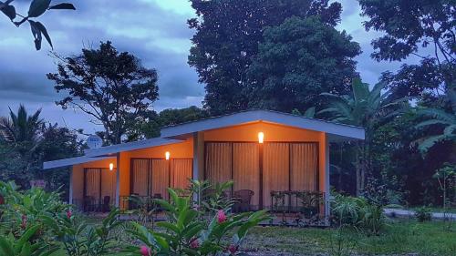 a small house with lights on the side of it at Yellow Tree Suites in Fortuna