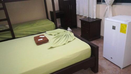 a bedroom with two bunk beds and a refrigerator at Hotel Casa Blanca in Las Peñas