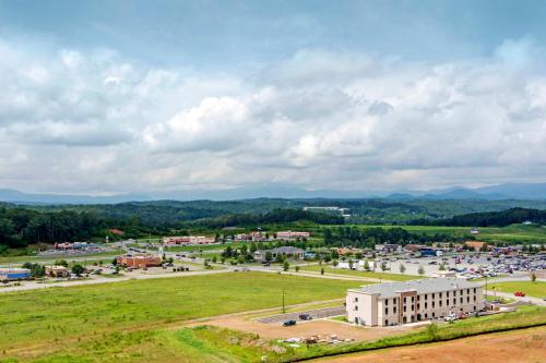 a large white building in a field with a parking lot at Comfort Inn & Suites East Ellijay in Ellijay