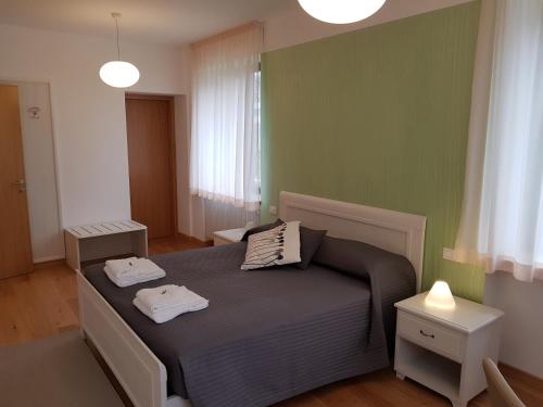 a bedroom with a bed with two towels on it at I Personaggi in Udine