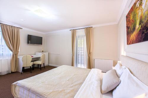 Ένα ή περισσότερα κρεβάτια σε δωμάτιο στο Prestige Hotel