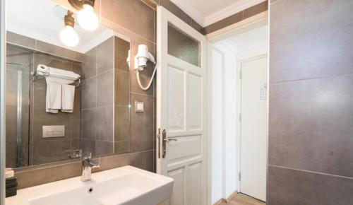 a bathroom with a sink and a shower at Yunus Beach Hotel in Marmaris