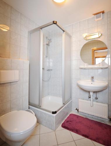 a bathroom with a shower and a toilet and a sink at Kalßwirt in Bad Aussee