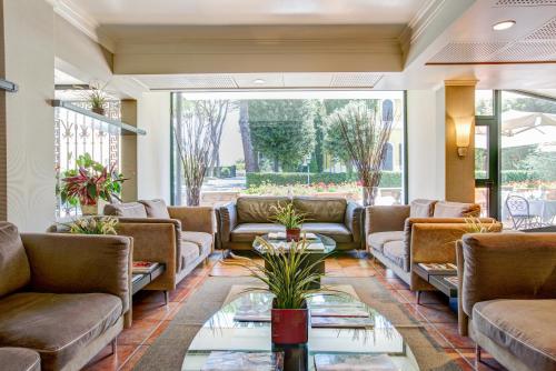 a living room with couches and a table at Appia Park Hotel in Rome