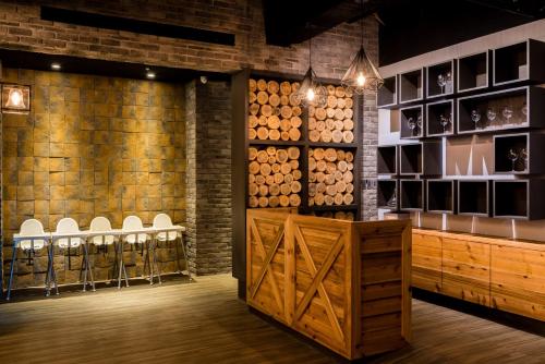 a wine tasting room with a wall of wine barrels at Traveller Inn TieHua Cultural and Creative Hotel in Taitung City