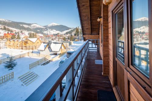 a balcony with a view of a snow covered mountain at Family Hotel Kaskad in Bukovel