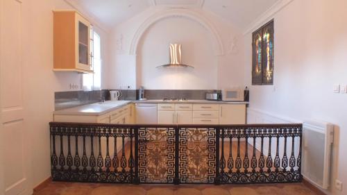 a kitchen with a sink and a counter top at La Chapelle du Domaine de Choisy in Abzac