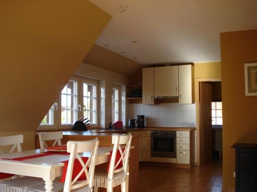 a kitchen with a table and chairs in it at The Cosy Home in Hodenhagen