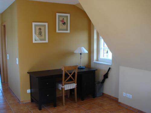 a desk in a room with a chair and a window at The Cosy Home in Hodenhagen
