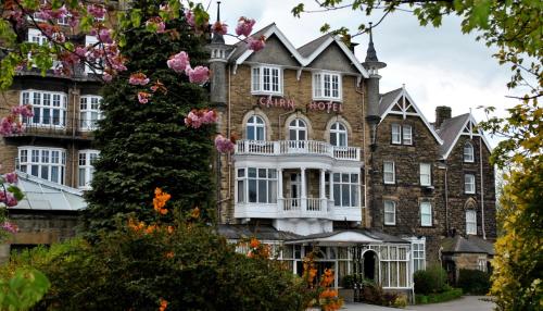 a large brick building with white windows at Cairn Hotel in Harrogate