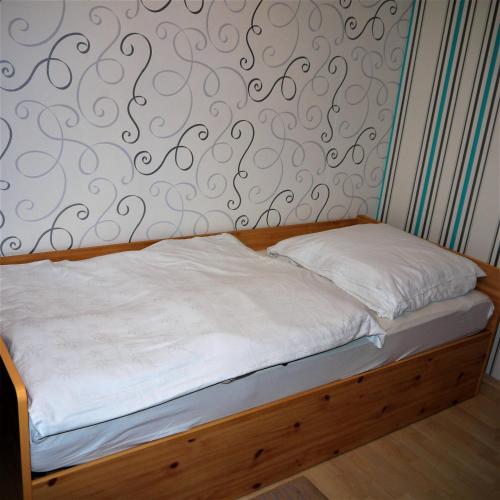 ハノーファーにあるMesse Zimmer in geteilter Wohnungの旋回模様の壁のベッド1台