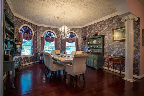 Rabbit Creek Bed & Breakfast في Versailles: غرفة طعام مع طاولة وكراسي