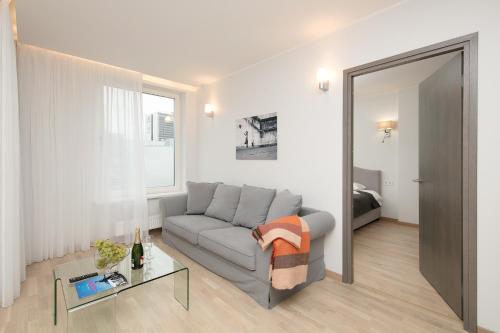 a living room with a couch and a table at 8ERA Business Executive Rotermanni Apartments in Tallinn