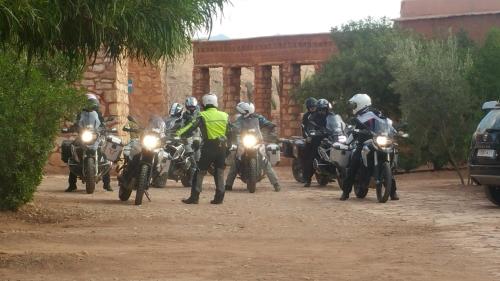 a group of people riding motorcycles on a dirt road at Dar Mouna in Aït Ben Haddou