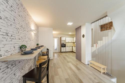 a kitchen and dining room with a brick wall at Downtown Royal Apartments in České Budějovice