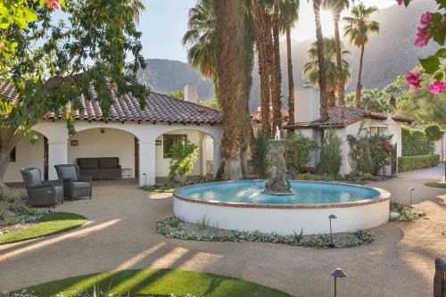 a house with a fountain in the middle of a yard at Ingleside Estate Hotel & Bungalows- Adults Only in Palm Springs