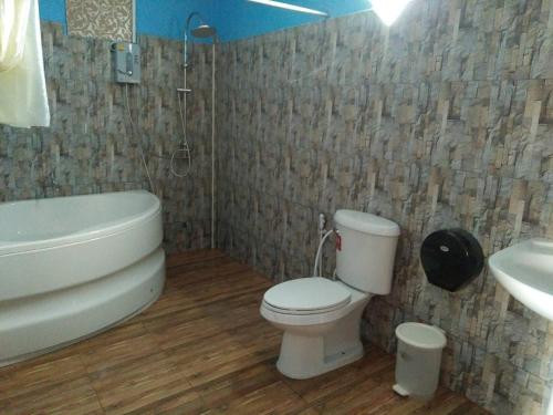 y baño con aseo, bañera y lavamanos. en Mailuay Resort, en Buriram