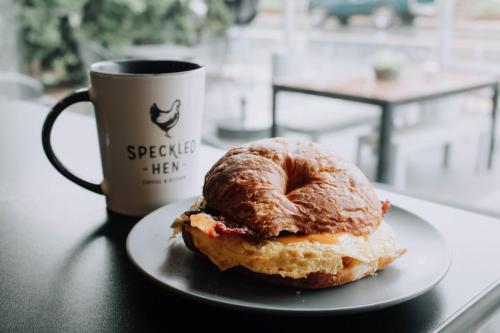 a donut on a plate next to a cup of coffee at The Carriage House at Strasburg in Strasburg