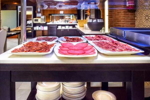 a buffet with several trays of food on a counter at Torreluz Centro in Almería