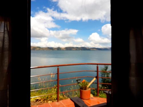 a view of a lake from a window at Cabañas Yukatan Lago de Tota in Tota
