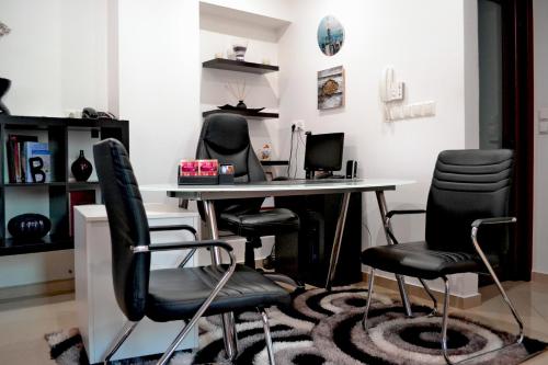 an office with a desk with chairs and a computer at Anesis in Ioannina