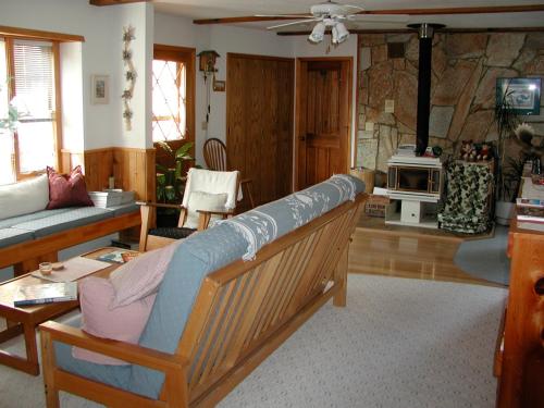 a living room with a couch and a table at Alaska Chalet Bed & Breakfast in Eagle River