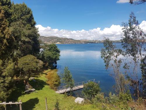 a view of a large lake with a dock at Cabañas Yukatan Lago de Tota in Tota