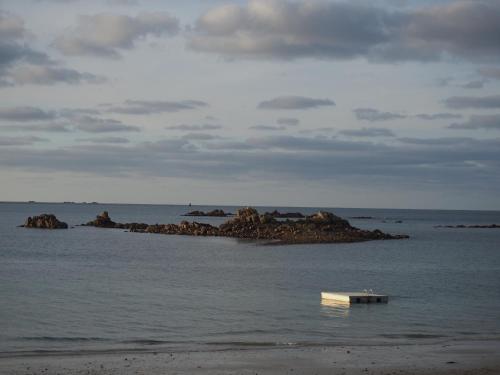 a bench sitting in the water on the beach at Seaview in Pleubian
